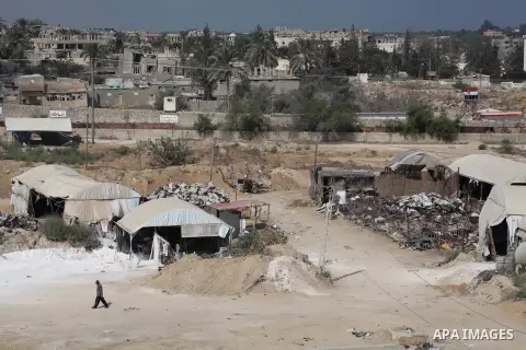 Tents cover entrances of tunnels (bottom) used for smuggling along the Gaza-Egypt border, near the southern Gaza Strip town of Rafah on August 06, 2012. Five gunmen who slew 16 Egyptian guards near the border with Israel...
