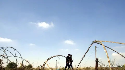 Palestinian security officers walk on the border between Egypt and the southern Gaza Strip, near Rafah August 6, 2012. Egypt has closed the terminal, the only gateway for Gaza's people after the deadly attack on its sold...