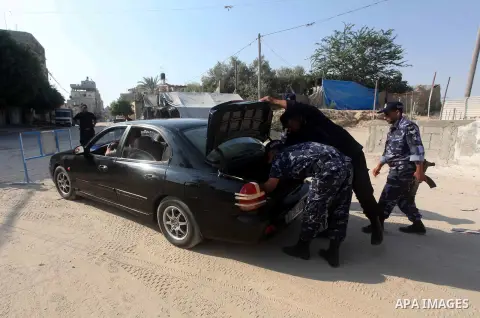 Palestinians Hamas security guard during searching cars near the border between Egypt and Gaza strip in Rafah town southern Gaza strip on, 06 August 2012. Reports state that at least five gunmen were killed after they tr...