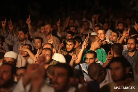 Palestinians chant slogans following a night prayer known as "Tarawih" leads by Palestinian Prime Minister in Gaza Ismail Haniyeh at a sit-in tent in Gaza city, solidarity with Egyptian soldiers who were killed on Rafah...