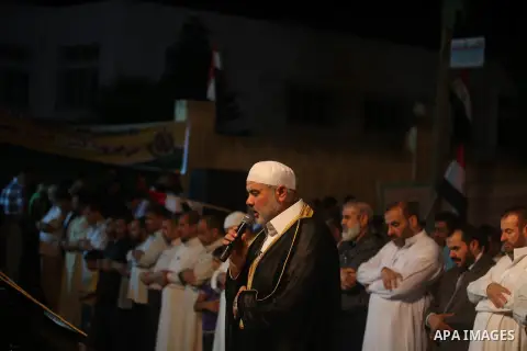 Palestinian Prime Minister in Gaza Ismail Haniyeh leads a night prayer known as "Tarawih" at a sit-in tent in Gaza city, solidarity with Egyptian soldiers who were killed on Rafah border between Egypt and the southern Ga...