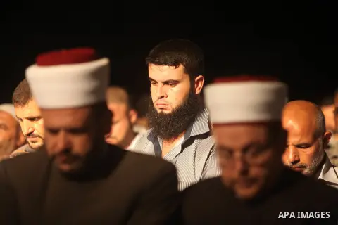 Palestinian Prime Minister in Gaza Ismail Haniyeh (not seen) leads a night prayer known as "Tarawih" at a sit-in tent in Gaza city, solidarity with Egyptian soldiers who were killed on Rafah border between Egypt and the...