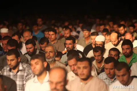 Palestinian Prime Minister in Gaza Ismail Haniyeh (not seen) leads a night prayer known as "Tarawih" at a sit-in tent in Gaza city, solidarity with Egyptian soldiers who were killed on Rafah border between Egypt and the...