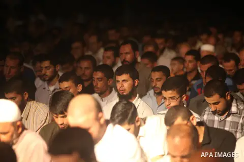 Palestinian Prime Minister in Gaza Ismail Haniyeh (not seen) leads a night prayer known as "Tarawih" at a sit-in tent in Gaza city, solidarity with Egyptian soldiers who were killed on Rafah border between Egypt and the...