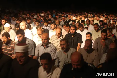 Palestinian Prime Minister in Gaza Ismail Haniyeh (not seen) leads a night prayer known as "Tarawih" at a sit-in tent in Gaza city, solidarity with Egyptian soldiers who were killed on Rafah border between Egypt and the...