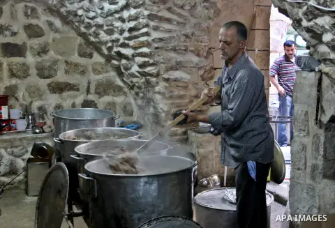 Palestinians prepare meals for distribution to poor families during Ramadan at a charity kitchen in the West Bank city of Nablus 07 August 2012. Muslims from all over the world are observing the holy month of Ramadan whi...