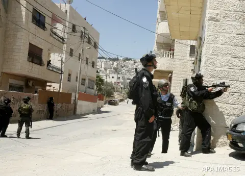 Israeli policemen run with their weapons during stormed in the West Bank town of Issawiya, in the West Bank, on Aug. 07, 2012. Photo by Mahfouz Abu Turk