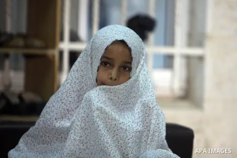 A Palestinian girl stands at the entrance to a mosque during a night prayer known as "Tarawih" at the mosque in the West Bank city of Ramallah on Aug. 07, 2012. Photo by Issam Rimawi