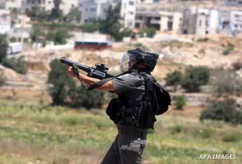 Israeli soldiers fire tear gas at Palestinian protestor during a Democratic Front for the Liberation of Palestine (DFLP) demonstration supporting prisoners in Israeli jails outside the Ofer military prison, near the West...