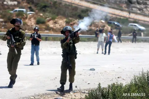 Israeli soldiers fire tear gas at Palestinian protestor during a Democratic Front for the Liberation of Palestine (DFLP) demonstration supporting prisoners in Israeli jails outside the Ofer military prison, near the West...