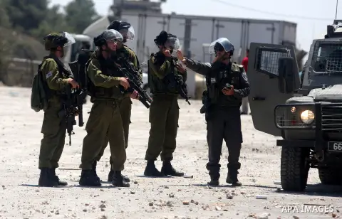 Israeli soldiers fire tear gas at Palestinian protestor during a Democratic Front for the Liberation of Palestine (DFLP) demonstration supporting prisoners in Israeli jails outside the Ofer military prison, near the West...