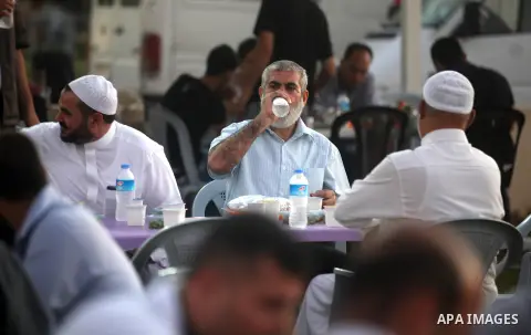 Palestinian Prime Minister in Gaza Strip, Ismail Haniyeh, breaks his fast with a Palestinian released Prisoners during the holy month of Ramadan, in Gaza city on 09 August 2012. Photo by Majdi Fathi