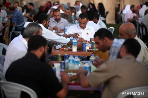 Palestinian Prime Minister in Gaza Strip, Ismail Haniyeh, breaks his fast with a Palestinian released Prisoners during the holy month of Ramadan, in Gaza city on 09 August 2012. Photo by Majdi Fathi