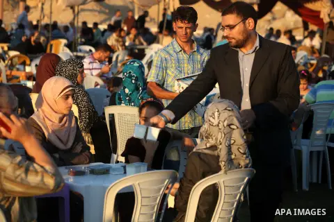 Palestinian Prime Minister in Gaza Strip, Ismail Haniyeh, breaks his fast with a Palestinian released Prisoners during the holy month of Ramadan, in Gaza city on 09 August 2012. Photo by Majdi Fathi