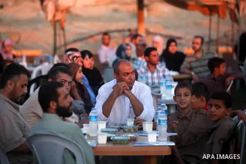Palestinian Prime Minister in Gaza Strip, Ismail Haniyeh, breaks his fast with a Palestinian released Prisoners during the holy month of Ramadan, in Gaza city on 09 August 2012. Photo by Majdi Fathi