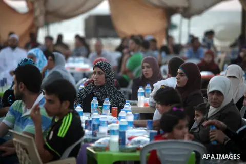 Palestinian Prime Minister in Gaza Strip, Ismail Haniyeh, breaks his fast with a Palestinian released Prisoners during the holy month of Ramadan, in Gaza city on 09 August 2012. Photo by Majdi Fathi