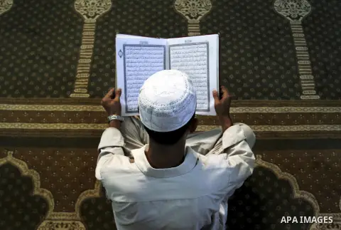 A Palestinian reads the Holy Koran in the Al-Omari mosque in the Gaza Strip, 09 August 2012. Muslims throughout the world prepare to celebrate the Eid al-Fitr festival after the Holy fasting month of Ramadan, in which th...