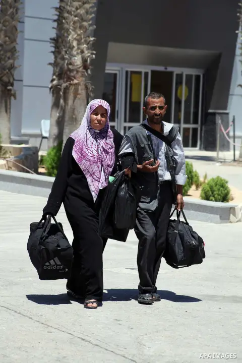 Palestinians return from Egypt cross into the southern Gaza Strip at the Rafah border crossing August 10, 2012. Egyptian military forces have captured six "terrorists" in the Sinai region after an attack on a police stat...