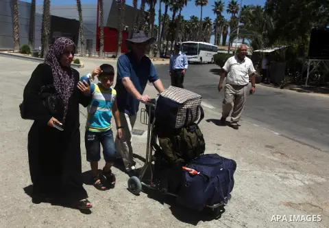 Palestinians return from Egypt cross into the southern Gaza Strip at the Rafah border crossing August 10, 2012. Egyptian military forces have captured six "terrorists" in the Sinai region after an attack on a police stat...