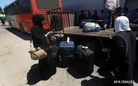 Palestinians transport their baggage into the southern Gaza Strip at the Rafah border crossing August 10, 2012. Egyptian military forces have captured six "terrorists" in the Sinai region after an attack on a police stat...