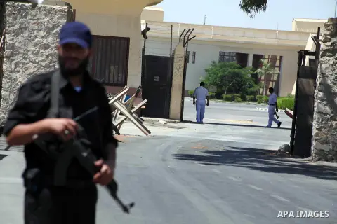 Egyptian policemen (back) and Palestinian soldier (front) stand guard at Rafah border crossing between Egypt and southern Gaza Strip August 10, 2012. Egyptian military forces have captured six "terrorists" in the Sinai r...