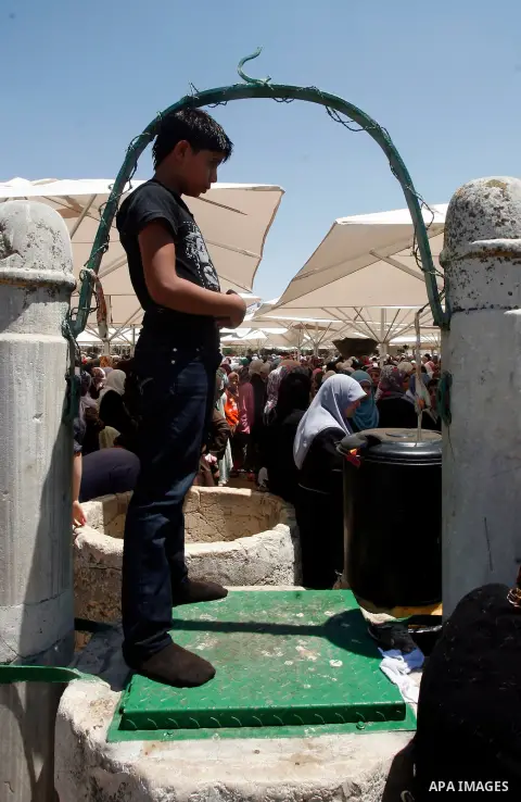 A Palestinian Muslim youth prays outside the Dome of the Rock mosque situated in the al-Aqsa mosque compound, Islam's third most holy site, on August 10, 2011 in old city of Jerusalem, on a Friday during the Muslim holy...