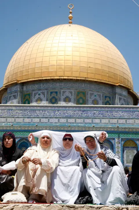 Muslim women pray outside the Dome of the Rock mosque situated in the al-Aqsa mosque compound, Islam's third most holy site, on August 10, 2011 in old city of Jerusalem, on a Friday during the Muslim holy fasting month o...