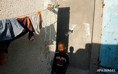 Palestinian children play in front of their house in Rafah refugee camp southern Gaza Strip, on 11 August 2012. Photo by Eyad Al Baba
