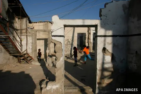 Palestinian children play in front of their house in Rafah refugee camp southern Gaza Strip, on 11 August 2012. Photo by Eyad Al Baba