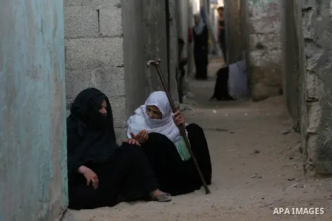 Palestinian women sit in front of their house during the fasting month of Ramadan in Rafah refugee camp southern Gaza Strip, on 11 August 2012. Photo by Eyad Al Baba