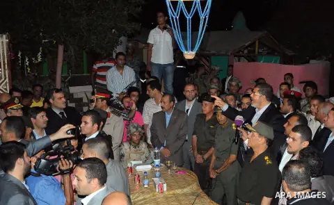 Newly elected Egyptian President Mohamed Mursi is flanked by Field Marshal Hussein Tantawi and Egyptian Armed Forces Chief of Staff Sami Anan as he talks to the soldiers at a checkpoint in al-Arish August 10, 2012. Egypt...