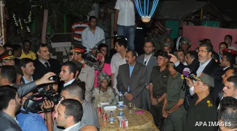 Newly elected Egyptian President Mohamed Mursi is flanked by Field Marshal Hussein Tantawi and Egyptian Armed Forces Chief of Staff Sami Anan as he talks to the soldiers at a checkpoint in al-Arish August 10, 2012. Egypt...