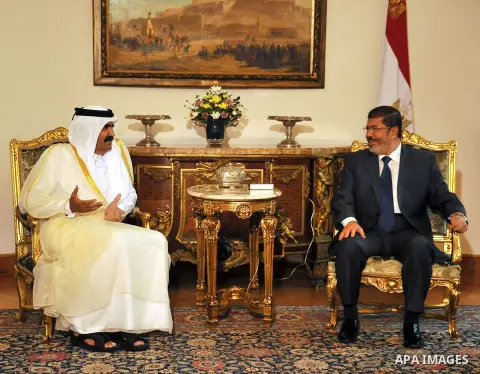 Egypt's President Mohamed Mursi, meets with Qatar's Emir Sheikh Hamad bin Khalifa al-Thani at the presidential palace in Cairo, August 11, 2012. Qatar said on Saturday it would deposit $2 billion at the Egyptian Central...