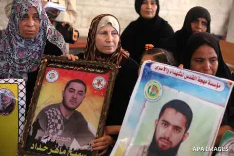 Palestinian women hold pictures of their relatives prisoners in Israeli jails as they gather in an activity calling for their liberty at the Red Cross headquarters in Gaza City on 13 August 2012. Photo by Majdi Fathi