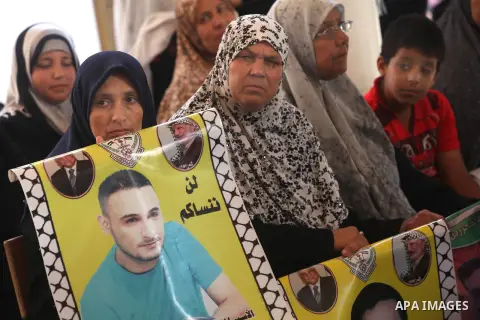 Palestinian women hold pictures of their relatives prisoners in Israeli jails as they gather in an activity calling for their liberty at the Red Cross headquarters in Gaza City on 13 August 2012. Photo by Majdi Fathi