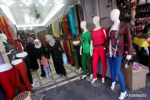 Palestinians shop at a market in Gaza city on Aug 13,2012, as Muslims over the world prepare to celebrate Eid al-Fitr, a three day holiday marking the end of the religious month of Ramadan in which believers abstain from...