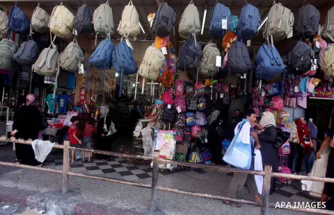 Palestinians shop at a market in Gaza city on Aug 13,2012, as Muslims over the world prepare to celebrate Eid al-Fitr, a three day holiday marking the end of the religious month of Ramadan in which believers abstain from...