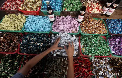 A Palestinian vendor displays his goods at a market in Gaza city on Aug 13,2012, as Muslims over the world prepare to celebrate Eid al-Fitr, a three day holiday marking the end of the religious month of Ramadan in which...