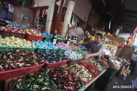 A Palestinian vendor displays his goods at a market in Gaza city on Aug 13,2012, as Muslims over the world prepare to celebrate Eid al-Fitr, a three day holiday marking the end of the religious month of Ramadan in which...
