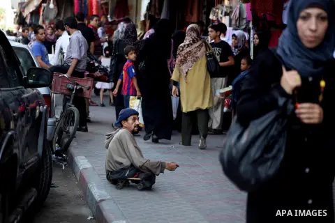 A Palestinian handicapped man sit at a market in Gaza city on Aug 13,2012, as Muslims over the world prepare to celebrate Eid al-Fitr, a three day holiday marking the end of the religious month of Ramadan in which believ...