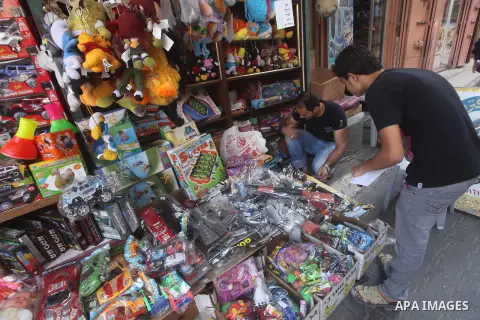 A Palestinian vendor displays his goods at a market in Gaza city on Aug 13,2012, as Muslims over the world prepare to celebrate Eid al-Fitr, a three day holiday marking the end of the religious month of Ramadan in which...