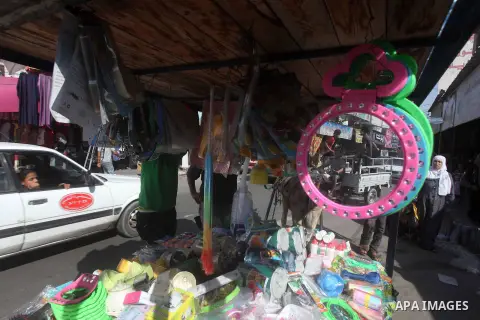 A Palestinian vendor displays his goods at a market in Gaza city on Aug 13,2012, as Muslims over the world prepare to celebrate Eid al-Fitr, a three day holiday marking the end of the religious month of Ramadan in which...