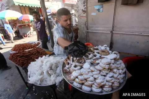 A Palestinian vendor displays his goods at a market in Gaza city on Aug 13,2012, as Muslims over the world prepare to celebrate Eid al-Fitr, a three day holiday marking the end of the religious month of Ramadan in which...