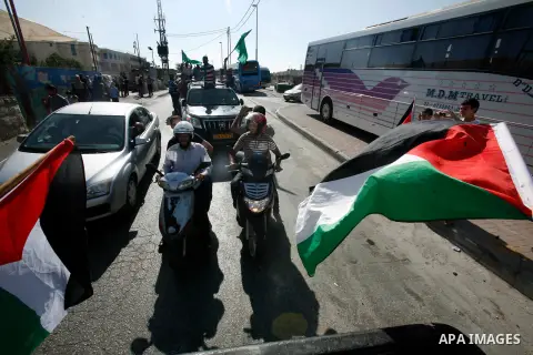 Palestinians celebrate after the Israeli authorities released prisoner Aws Ibrahim Hamada in neighborhood of Sour Baher in Jerusalem on Aug 13, 2012. Hamada spent 10 years in prison before the Israeli authorities release...
