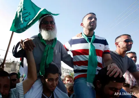 Palestinians celebrate after the Israeli authorities released prisoner Aws Ibrahim Hamada in neighborhood of Sour Baher in Jerusalem on Aug 13, 2012. Hamada spent 10 years in prison before the Israeli authorities release...