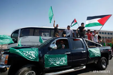 Palestinians celebrate after the Israeli authorities released prisoner Aws Ibrahim Hamada in neighborhood of Sour Baher in Jerusalem on Aug 13, 2012. Hamada spent 10 years in prison before the Israeli authorities release...