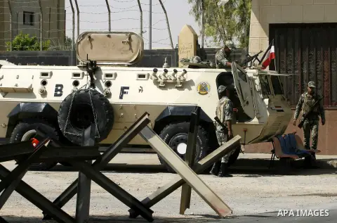 An Egyptian soldier keeps guard as he sits atop a military vehicle at Rafah border crossing between Egypt and southern Gaza Strip August 14, 2012. Egypt opened the crossing temporarily on Tuesday, but just for three days...