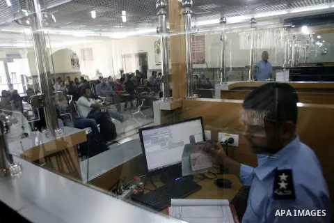 Palestinian passengers wait at a station in Khan Younis in the southern Gaza Strip, before entering Egypt through Rafah border crossing August 14, 2012. Egypt opened the crossing temporarily on Tuesday, but just for thre...