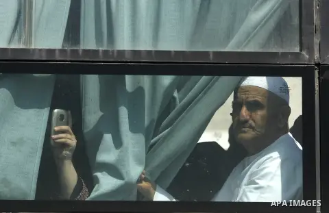 A Palestinian man sits on a bus as he crosses the Rafah border crossing August 14, 2012. Egypt opened the crossing temporarily on Tuesday, but just for three days, mainly to permit travel for humanitarian cases. The Isla...