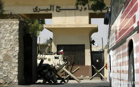 An Egyptian soldier keeps guard as he sits atop a military vehicle at Rafah border crossing between Egypt and southern Gaza Strip August 14, 2012. Egypt opened the crossing temporarily on Tuesday, but just for three days...